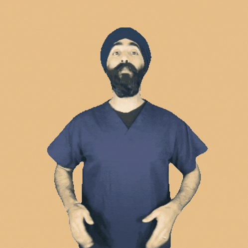 A Man With A Beard Wearing A Blue Scrub Top And A Black Hat GIF