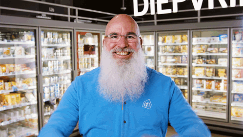 A Man With A Beard Wearing A Blue Shirt With An On Logo On It GIF