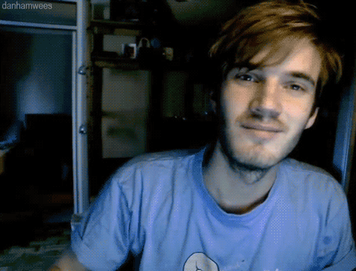 A Man With A Beard Wearing A Blue Shirt With Danhamwees Written On The Bottom GIF