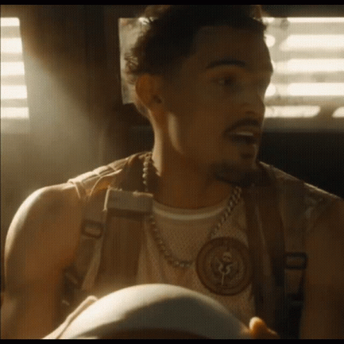 A Man With A Beard Wearing A Chain Around His Neck GIF