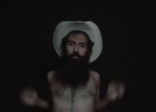 A Man With A Beard Wearing A Cowboy Hat GIF