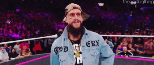 a man with a beard wearing a denim jacket that says god on it