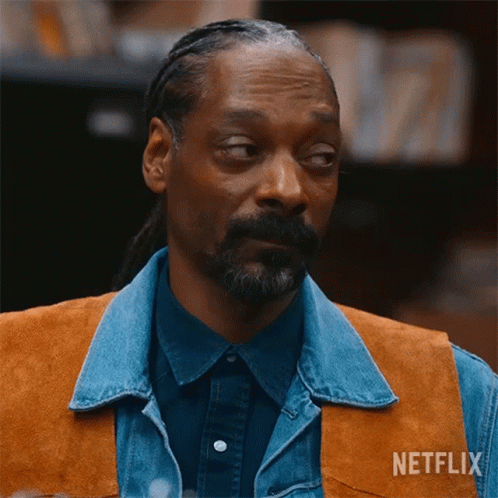 A Man With A Beard Wearing A Denim Vest And A Netflix Logo On His Chest GIF