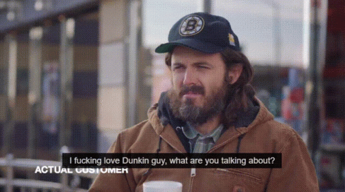 A Man With A Beard Wearing A Dunkin Donuts Hat Talks To Another Man GIF