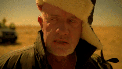 A Man With A Beard Wearing A Fur Hat And A Jacket GIF