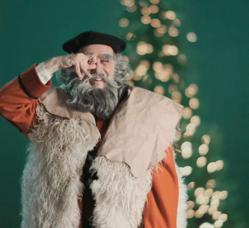 A Man With A Beard Wearing A Fur Vest And A Black Hat GIF