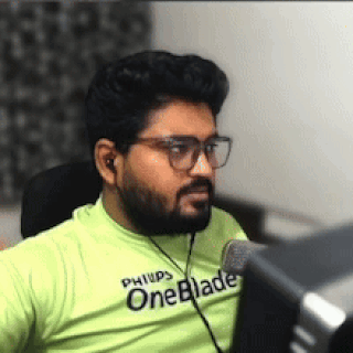 A Man With A Beard Wearing A Green Shirt That Says Oneblade GIF