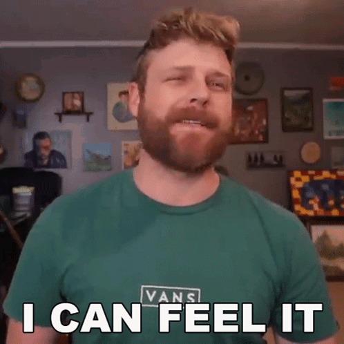 A Man With A Beard Wearing A Green Vans Shirt Says I Can Feel It GIF