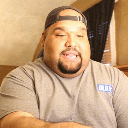 A Man With A Beard Wearing A Grey Shirt That Says Olde GIF