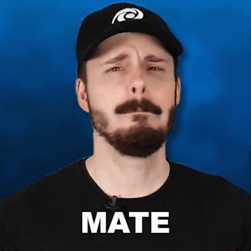 A Man With A Beard Wearing A Hat And A Black Shirt Is Making A Sad Face . GIF