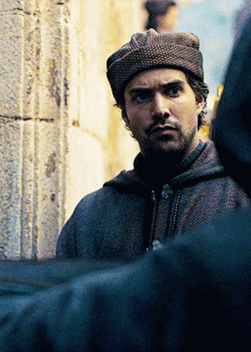 A Man With A Beard Wearing A Hat And A Hooded Jacket GIF