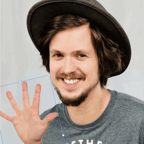 A Man With A Beard Wearing A Hat And A Shirt That Says The GIF