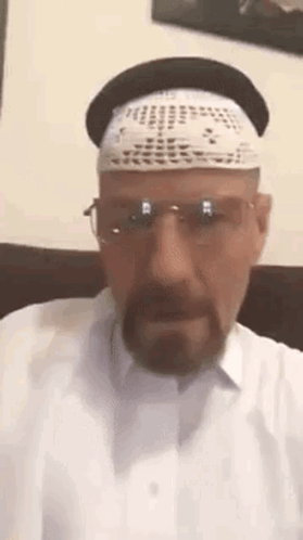 A Man With A Beard Wearing A Hat And Glasses . GIF