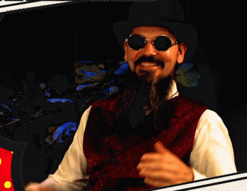 A Man With A Beard Wearing A Hat And Sunglasses GIF