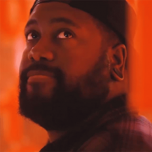 A Man With A Beard Wearing A Hat Looks Up GIF