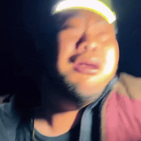 A Man With A Beard Wearing A Hat With A Yellow Light On It GIF