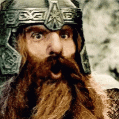 A Man With A Beard Wearing A Helmet Has His Mouth Open GIF
