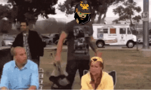 A Man With A Beard Wearing A Helmet With A Eagle On It Stands In Front Of A White Van GIF