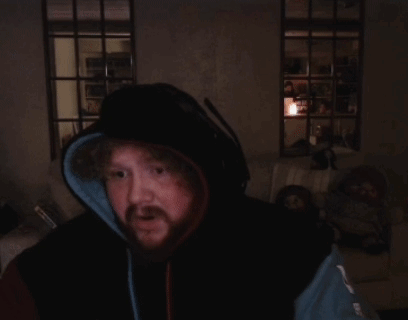A Man With A Beard Wearing A Hoodie And Headphones Is Praying GIF