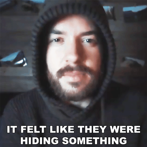 a man with a beard wearing a hoodie with the words it felt like they were hiding something