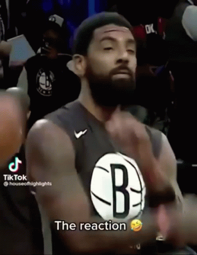 A Man With A Beard Wearing A Jersey That Says The Reaction GIF