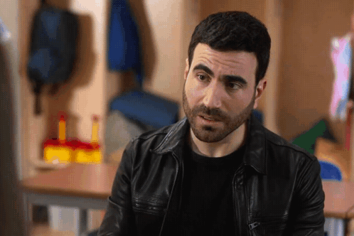 A Man With A Beard Wearing A Leather Jacket GIF