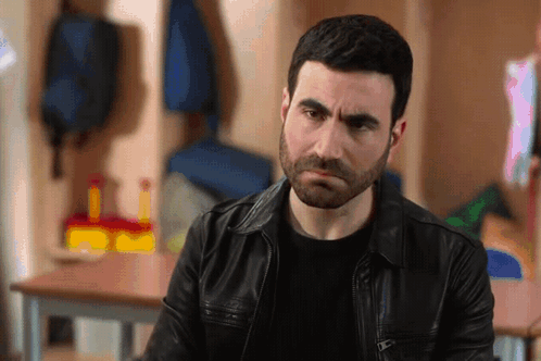A Man With A Beard Wearing A Leather Jacket GIF
