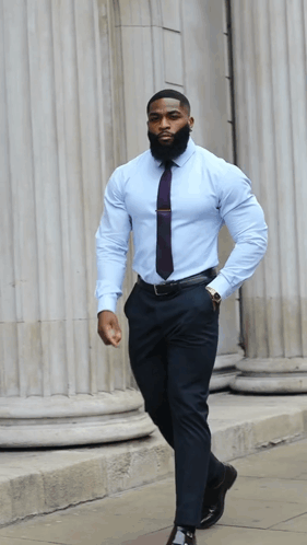 A Man With A Beard Wearing A Light Blue Shirt And Tie GIF