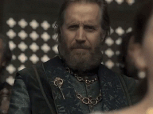 a man with a beard wearing a necklace with keys on it