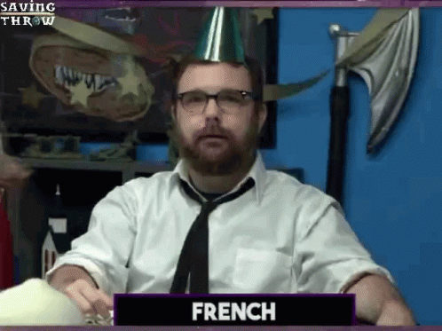 A Man With A Beard Wearing A Party Hat And Tie Is Called French GIF