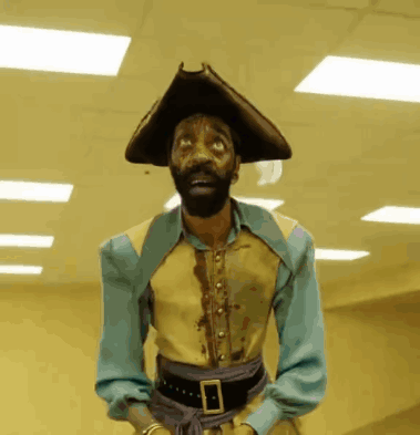 A Man With A Beard Wearing A Pirate Outfit GIF