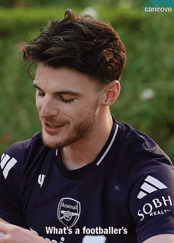 A Man With A Beard Wearing A Purple Arsenal Jersey GIF
