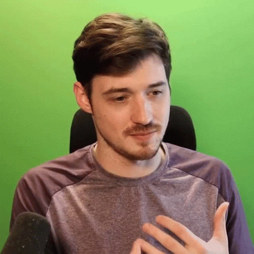 Man With Beard In Purple Shirt In Front Of Green Screen GIF