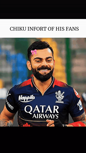 A Man With A Beard Wearing A Qatar Airways Shirt Smiles GIF