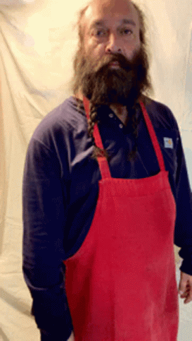A Man With A Beard Wearing A Red Apron And A Blue Shirt GIF