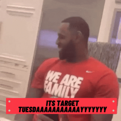 a man with a beard wearing a red shirt that says we are family