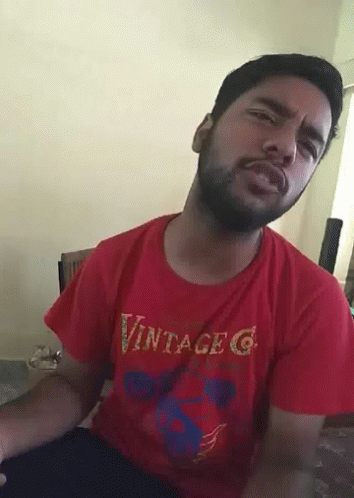 A Man With A Beard Wearing A Red Vintage G T-Shirt GIF