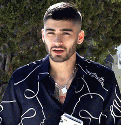 A Man With A Beard Wearing A Shirt That Says Louis Vuitton On It GIF