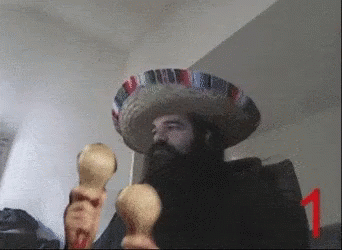 A Man With A Beard Wearing A Sombrero Holds Maracas GIF
