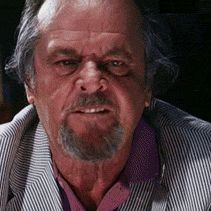 A Man With A Beard Wearing A Striped Jacket And A Purple Shirt GIF