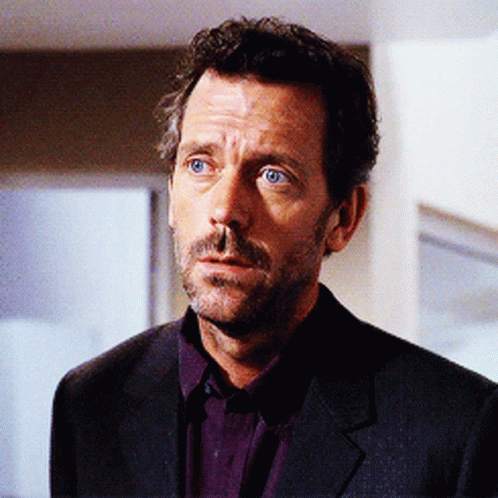 A Man With A Beard Wearing A Suit And Purple Shirt GIF