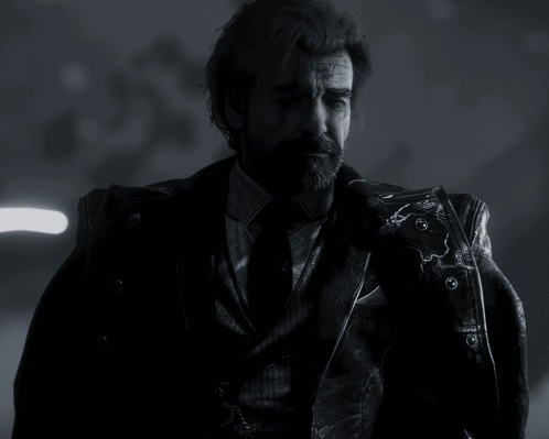 A Man With A Beard Wearing A Suit And Tie Is Standing In The Dark GIF