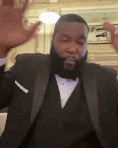 A Man With A Beard Wearing A Tuxedo And A White Pocket Square GIF