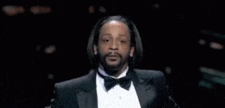 A Man With A Beard Wearing A Tuxedo And Bow Tie Is Making A Funny Face . GIF