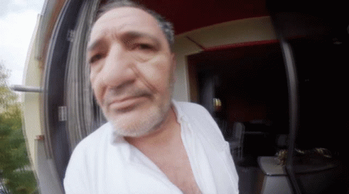 A Man With A Beard Wearing A White Shirt GIF