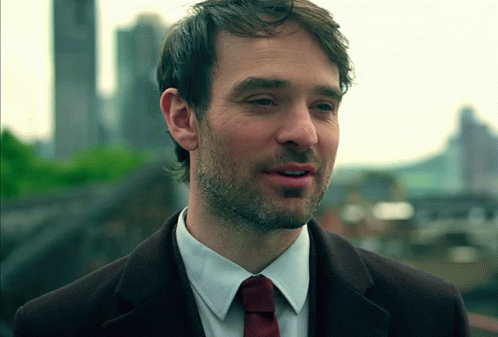 A Man With A Beard Wearing A White Shirt And A Red Tie GIF