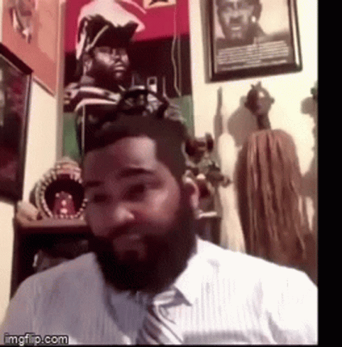 A Man With A Beard Wearing A White Shirt And A Tie GIF