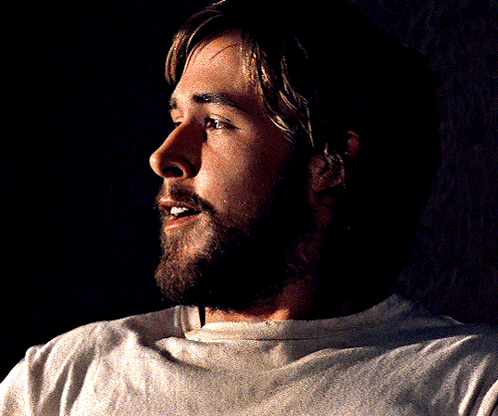A Man With A Beard Wearing A White Shirt Is Smiling GIF