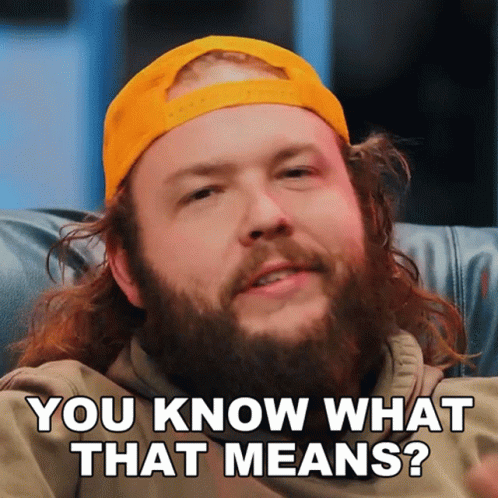 A Man With A Beard Wearing A Yellow Hat Is Asking You Know What That Means GIF