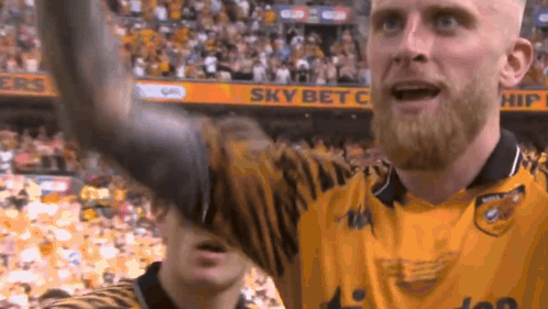 A Man With A Beard Wearing A Yellow Jersey With The Word Sky Bet On The Back GIF